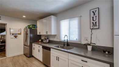 Kitchen sink, window looks to front of property.