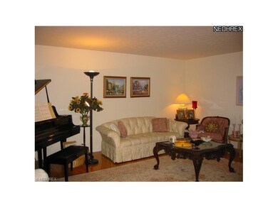 The formal living room is light, bright and neutra