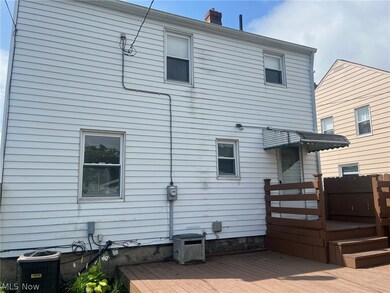 Back of house with a deck