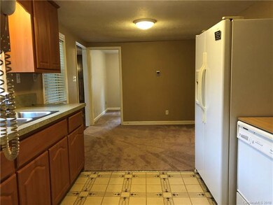 View of kitchen and dining room from laundry room