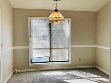 Unfurnished dining area featuring carpet flooring,