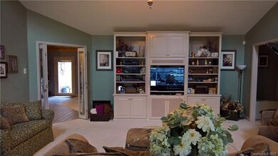 2nd view of living room with built in cabinetry, p