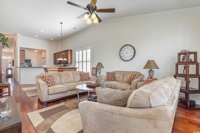 Living room featuring ornamental molding, vaulted 