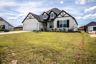 View of front of house featuring a garage and a fr