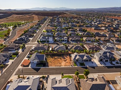 Aerial overview of property's location with a mountain backdrop and nearby suburban area