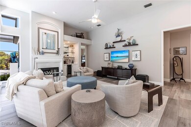 Living area featuring a glass covered fireplace, l