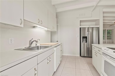 Kitchen with white appliances, light countertops, 