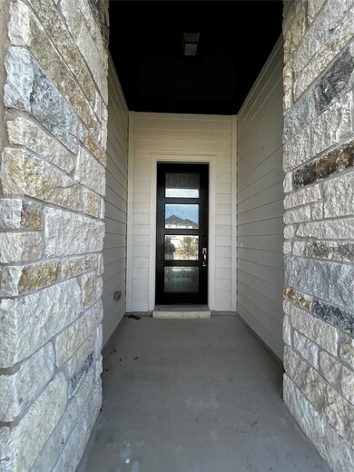 Doorway to property featuring stone siding