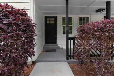 Doorway to property with covered porch