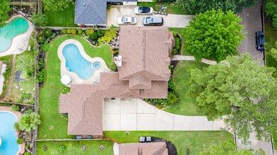 Here's that aerial view that gives you a true feel for the space in this backyard.  There is a full, three car garage with expanded driveway parking and an equipment shed off the back of the garage for storage.  Peruse the remaining photos and you'll see the third bay is a full workshop with functioning A/C (but could easily be used for a car if preferred).