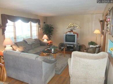 The living room offers hardwood floors and a large