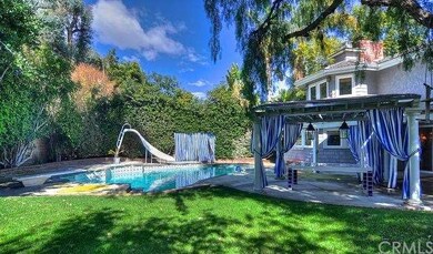 The large backyard that features a pool with a sli