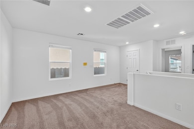 Unfurnished room with carpet floors and recessed lighting