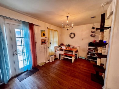 Dining area with a chandelier, visible vents, and