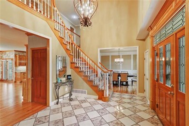 A leaded-glass door frames the two-story entry.  T