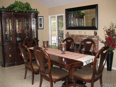 Spacious dining room with fire place and window to