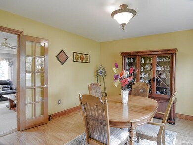 Formal dining room with wood floors.