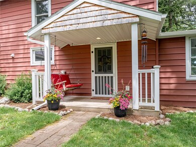 Freshly mulched landscaping surround front porch.