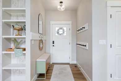 Foyer with wood finished floors and baseboards