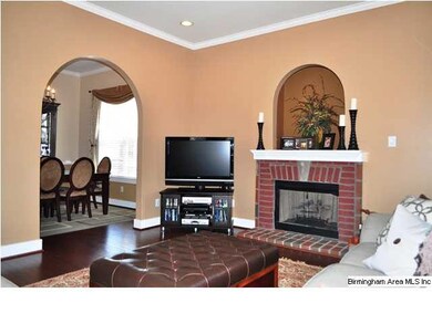 great room : hardwood floors, crown molding, reces