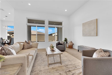 Living area with carpet floors, recessed lighting,