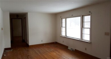 Livingroom with hardwoods would need some refinish