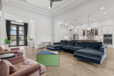 Living area featuring recessed lighting, light wood-type flooring, ceiling fan, and ornamental molding