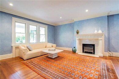 Spacious living room with decorative fireplace, cr