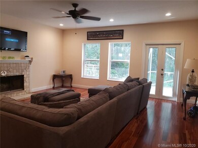 Large den with hardwood flooring and beautiful par