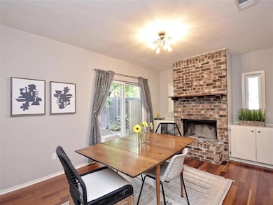 Dining area with a fireplace and dark wood finish