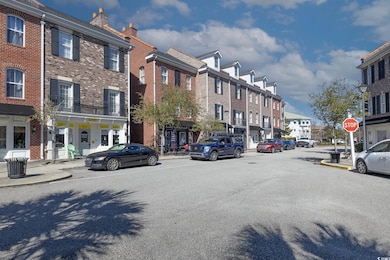 View of street with street lights, curbs, traffic 