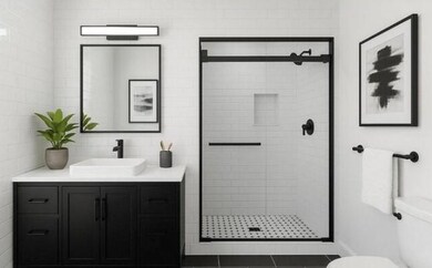 Bathroom with vanity, a shower stall, and toilet