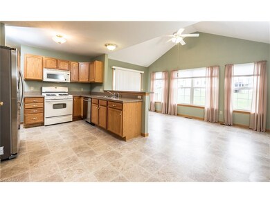 The fully applianced kitchen features a gas stove,