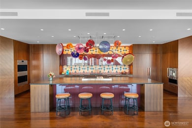 Substantial island to anchor your culinary creations. Antique leathered brown granite countertops, plentiful storage and a Moroccan Tabarka tile backsplash by Ann Sacks. Concealed Zephyr range hood over 6 burner (+griddle) Wolf. 2 Wolf ovens (with convection). 2 Cove dishwashers. Sub-Zero refrigerator, freezer + additional refrigerator drawers. Microwave. Espresso maker. Dornbracht ultra-hot and cold filtered water dispenser.