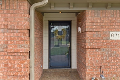 Property entrance featuring brick siding