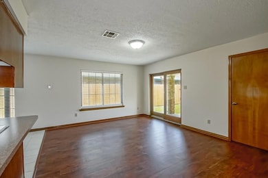 Den are with sliding glass door that access the co