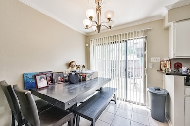 The dining area has crown molding, tile floors and