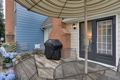 Wooden deck featuring area for grilling and outdoo
