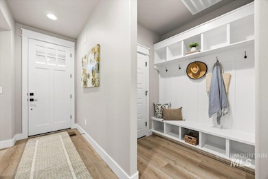 Mudroom with light wood-style flooring and recessed lighting