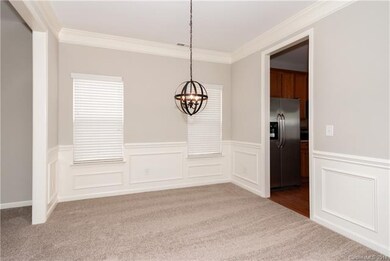Dining room features upgraded light fixture, wains