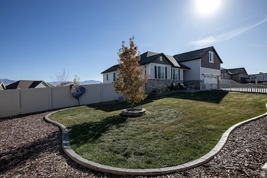 View of home's exterior with a fenced backyard and stone siding
