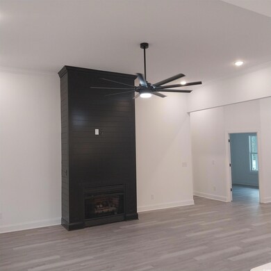 Unfurnished living room featuring ornamental moldi