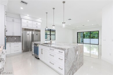 Kitchen with a tray ceiling, stainless steel appli