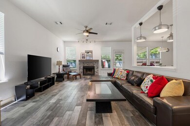 Living area with wood finished floors, a fireplac