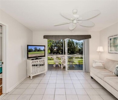 Living room with healthy amount of natural light, ceiling fan, and light tile patterned floors