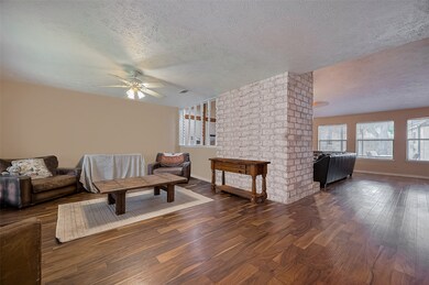 Expanded open living with rich wood floors and a c
