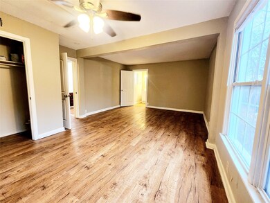 Unfurnished bedroom with light wood-style floors, ceiling fan, and a closet