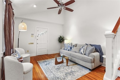 Living Room with hardwood floors, vaulted ceilings