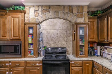 Kitchen with stainless steel microwave, crown mold