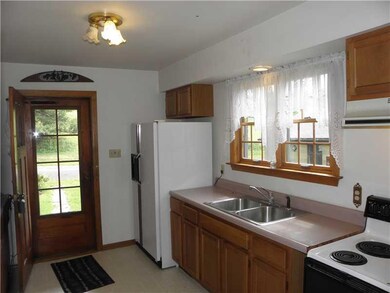 Kitchen. Side Door Entrance off Covered Porch into